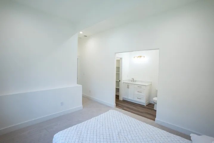 Bright interior space featuring a light-colored carpet, white walls, and a recessed opening