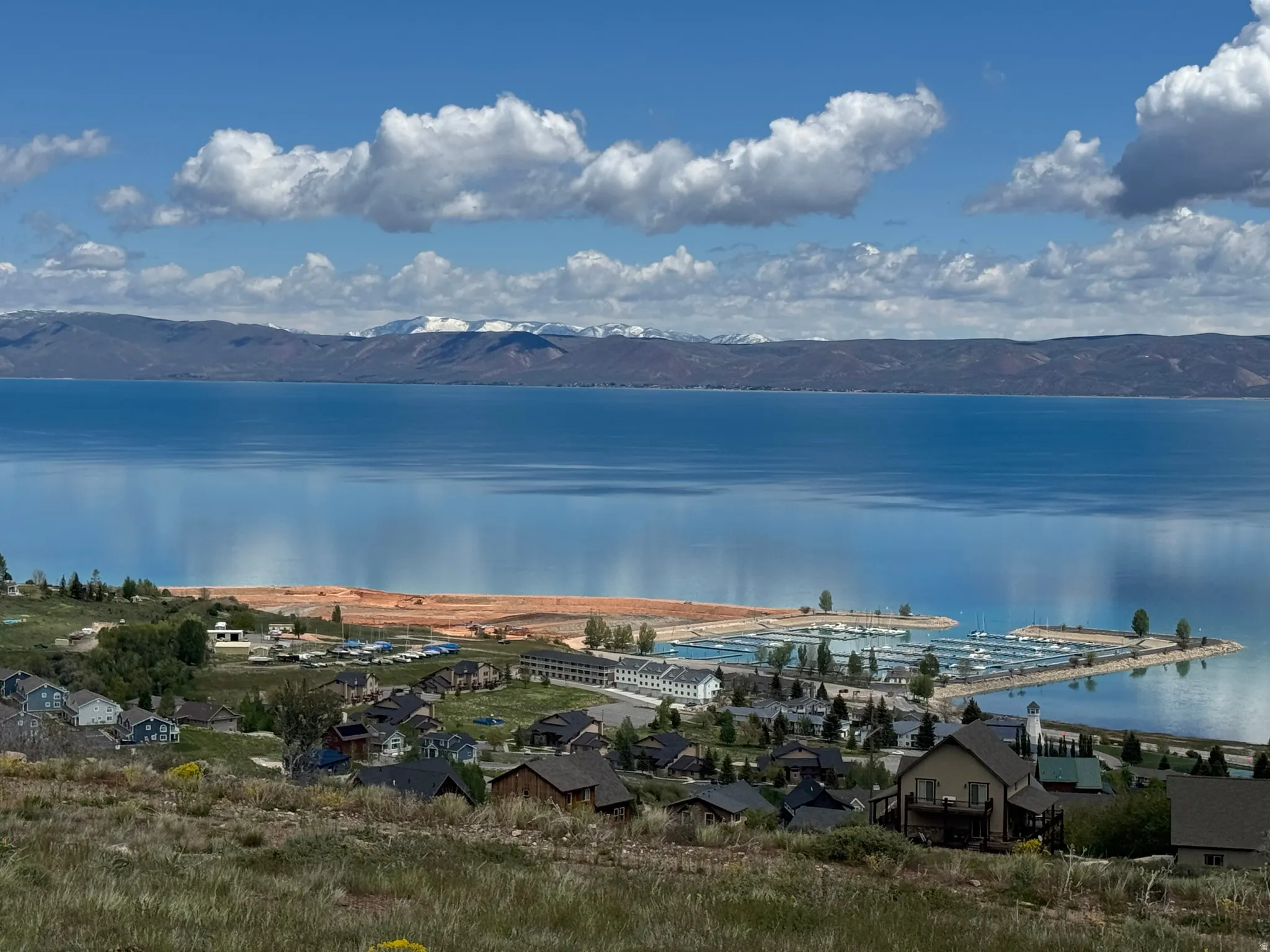 Expansive water body with a marina featuring multiple boat slips