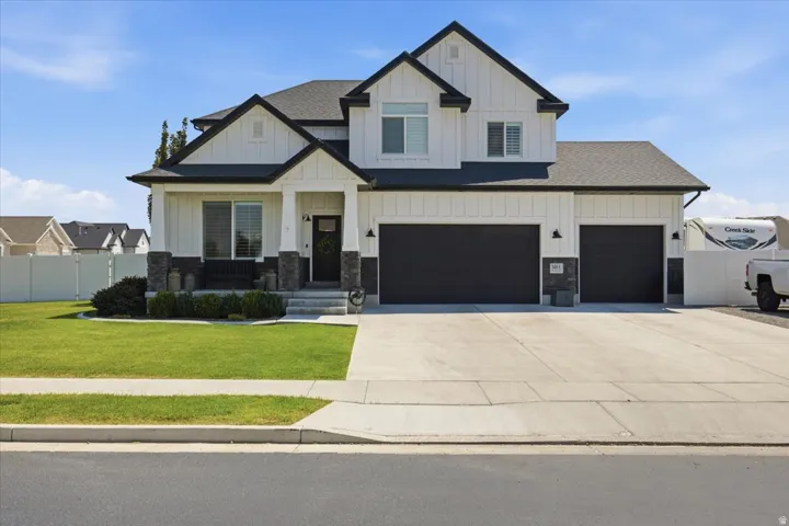 Contemporary two-story exterior with white vertical siding and dark trim