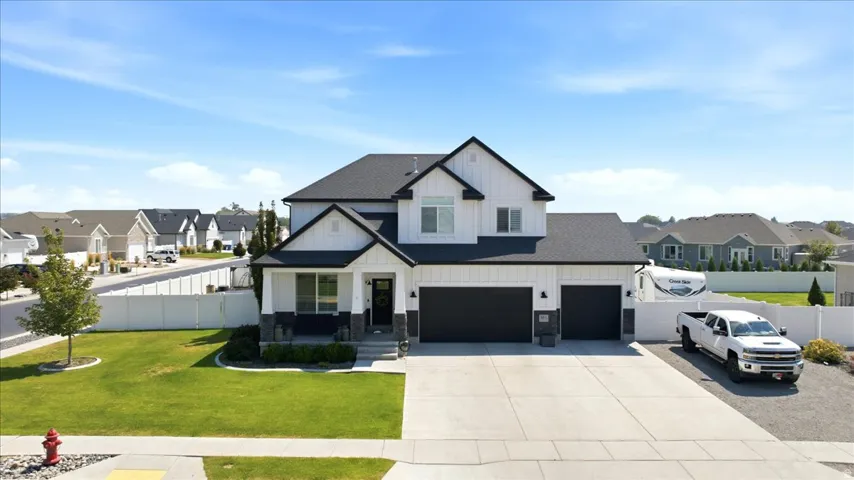 Two-story residence with a dark roof and white exterior siding