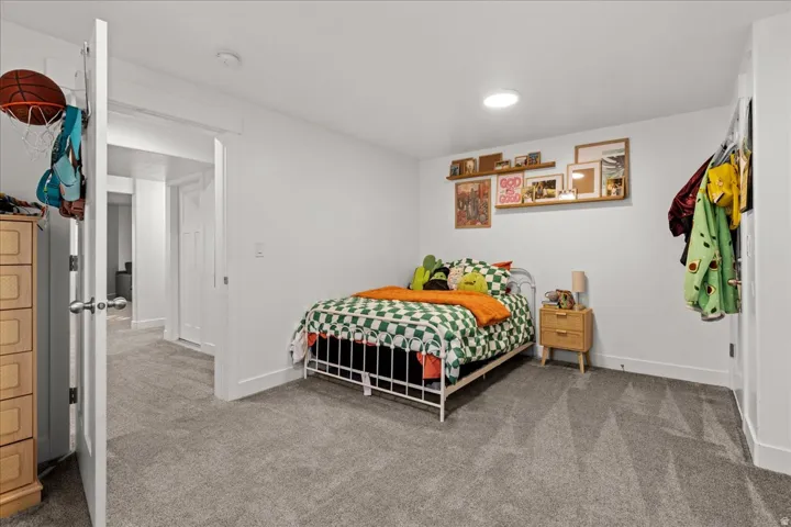 Room featuring neutral gray carpet flooring, white walls, recessed ceiling lighting, and white trim