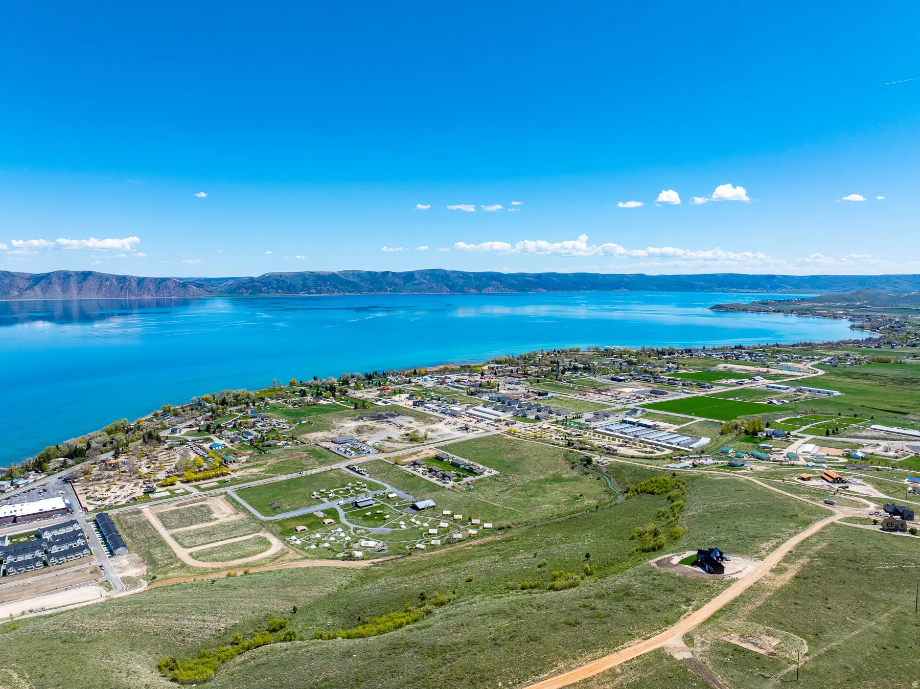 Expansive aerial perspective showcasing a large body of water bordered by distant mountains