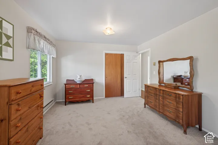 Carpeted room featuring a double-paned window, neutral wall paint, and a white interior door