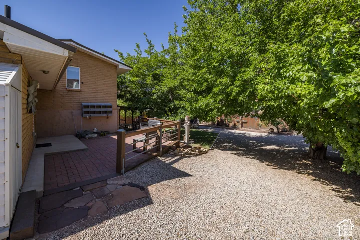 Expansive outdoor patio featuring brick pavers and flagstone accents
