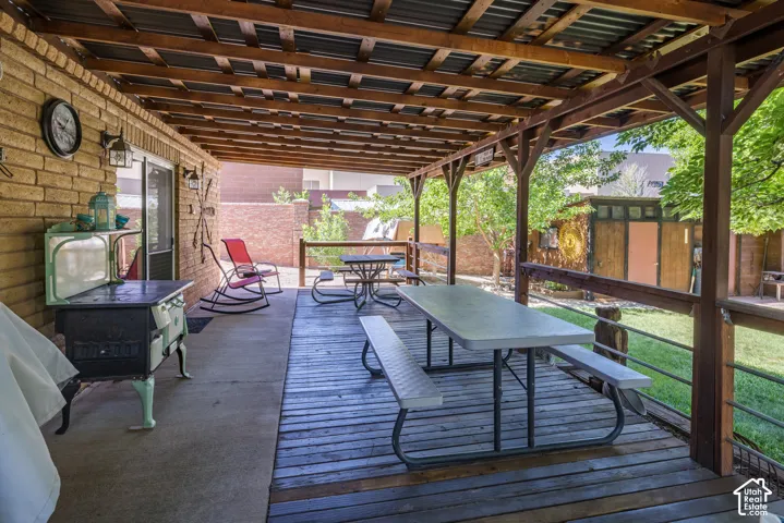 Outdoor living space featuring a covered patio and an elevated wooden deck