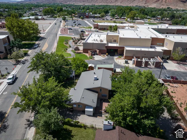 Aerial view of a property featuring a metal roof and a fenced yard