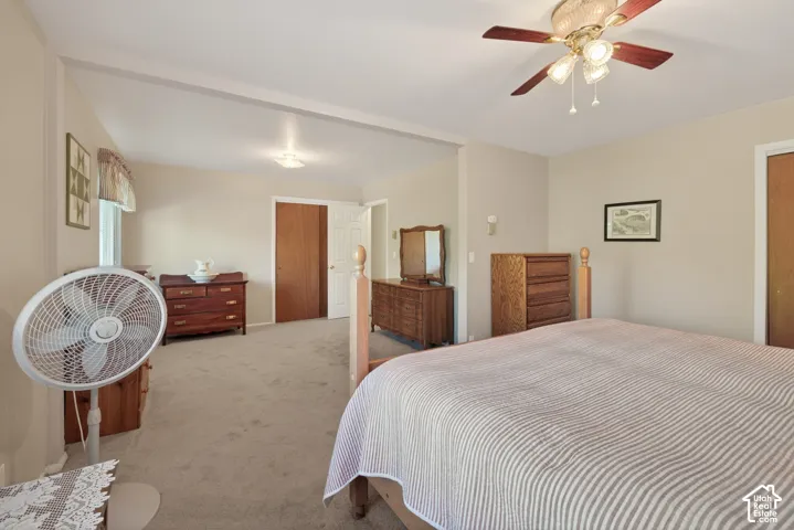 Carpeted interior space featuring a ceiling fan with integrated lighting
