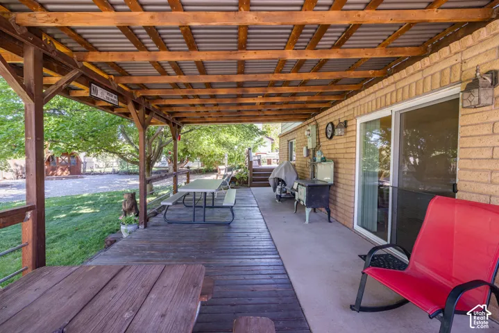 Covered outdoor deck with exposed wood rafters and a corrugated metal roof
