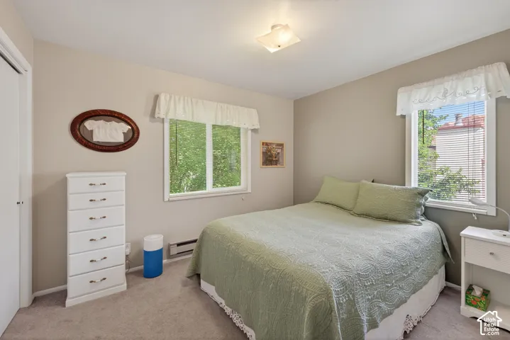 Carpeted room with neutral wall tones and a ceiling-mounted light fixture
