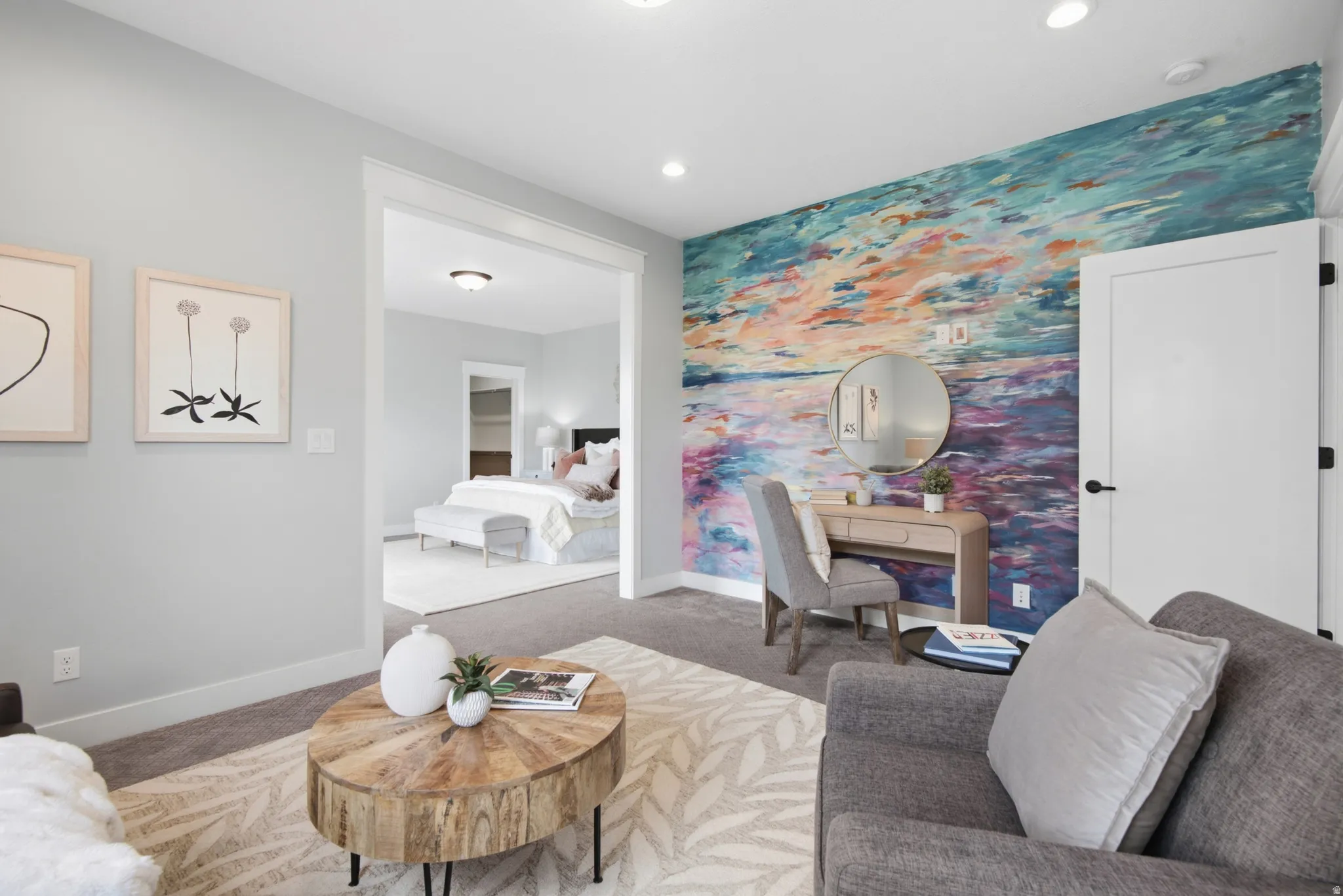 Primary bedroom sitting room/office. Recessed lighting, light gray wall finish, white interior door, white trim, and light-colored carpeting