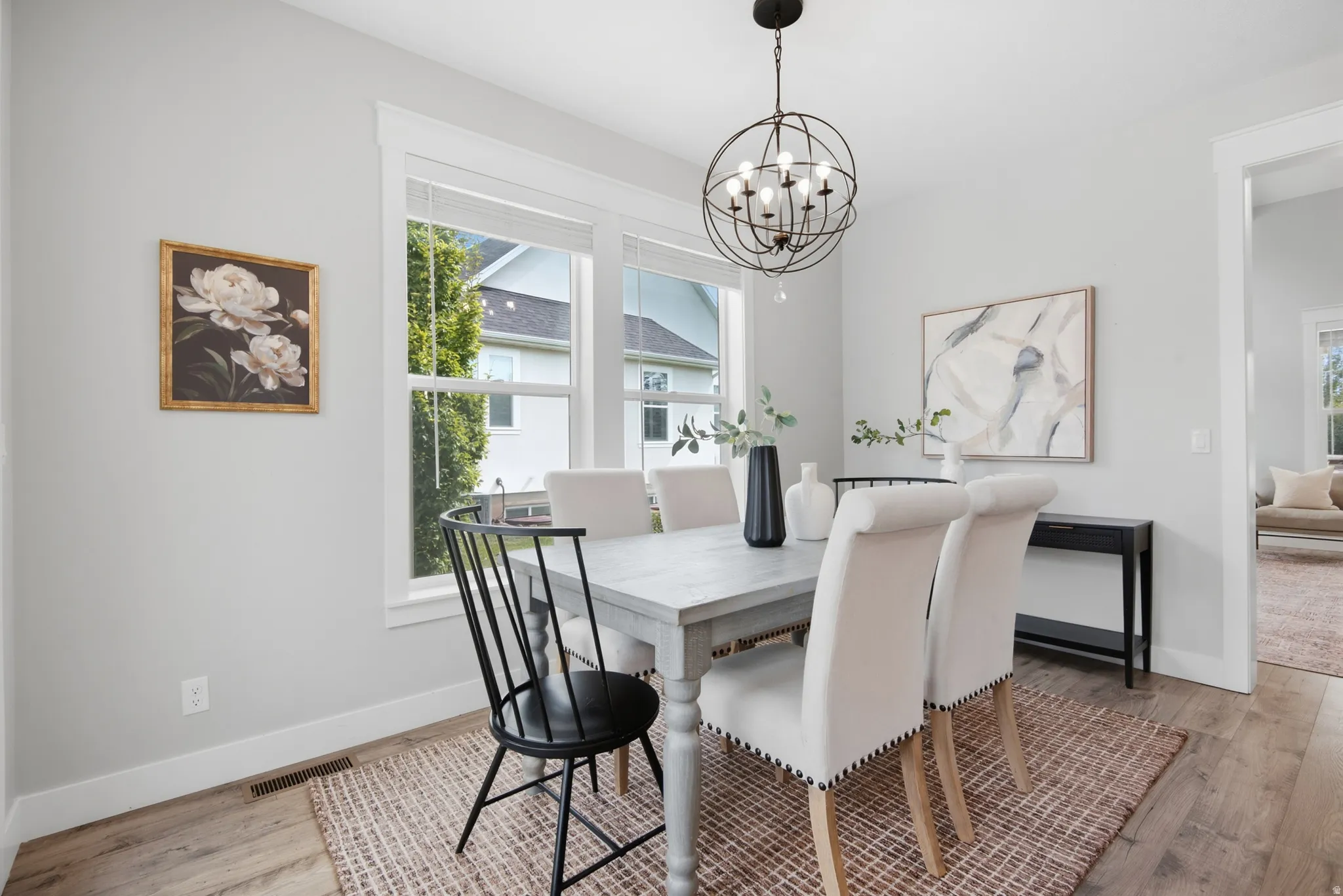 Recessed lighting, wood-finish flooring, and crisp white trim