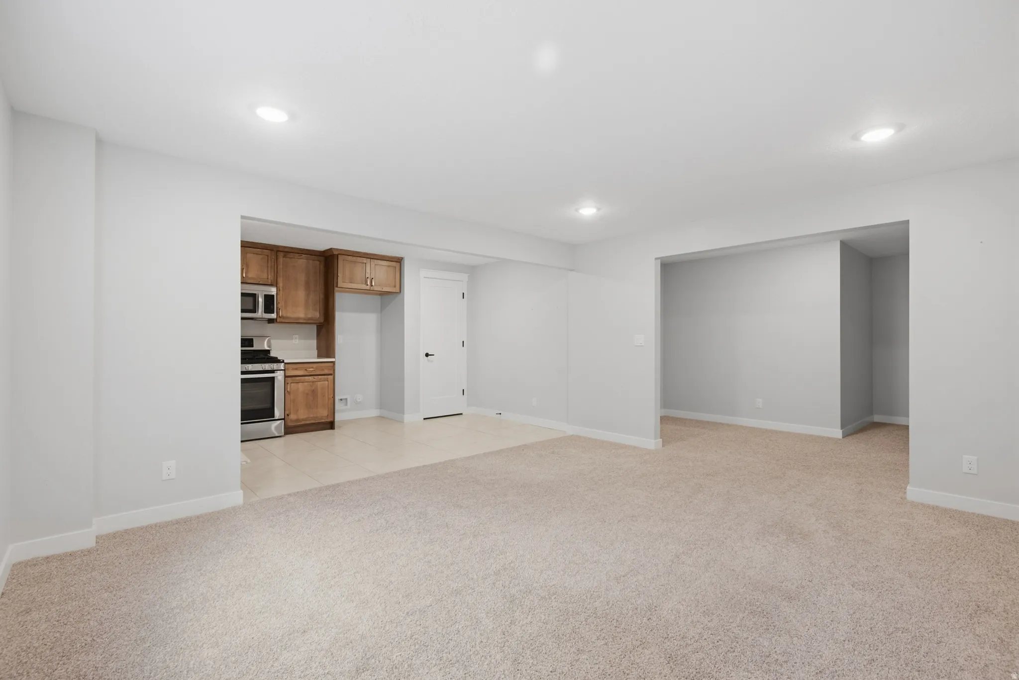 Basement ADU great room. Open-concept room featuring recessed lighting and neutral-toned carpeting