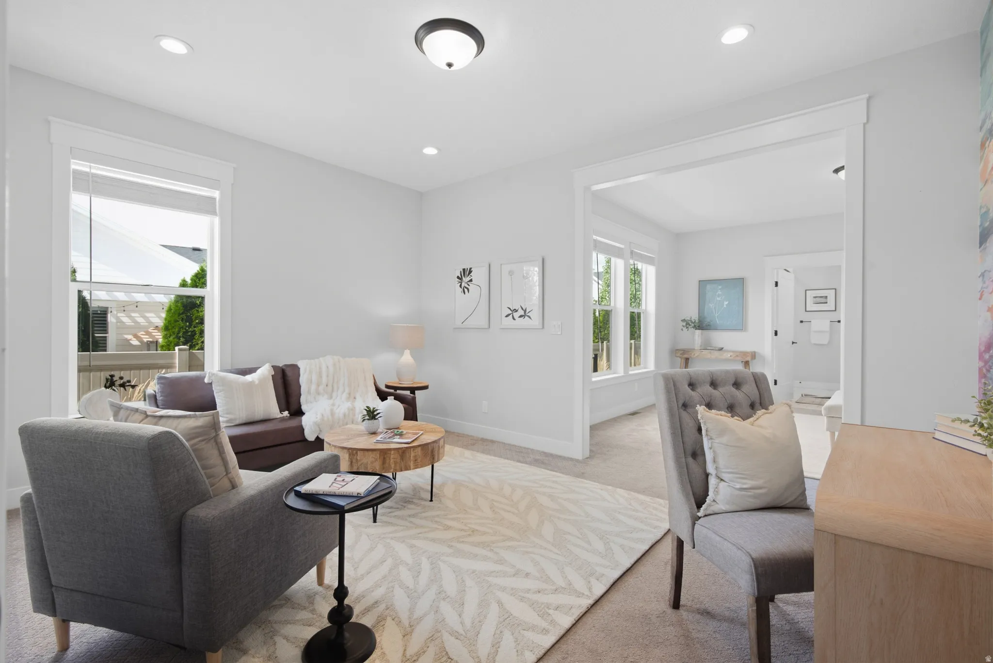 Primary bedroom sitting room/office. Recessed lighting and ceiling-mounted fixture illuminate the space