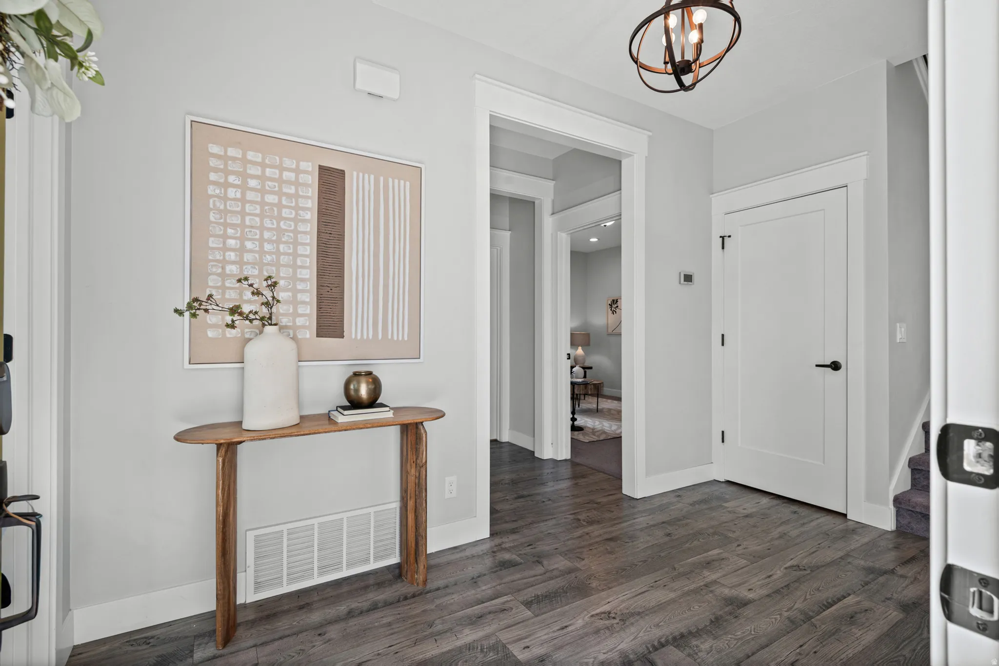 Hardwood-finish flooring, white trim, recessed lighting, and a contemporary ceiling fixture