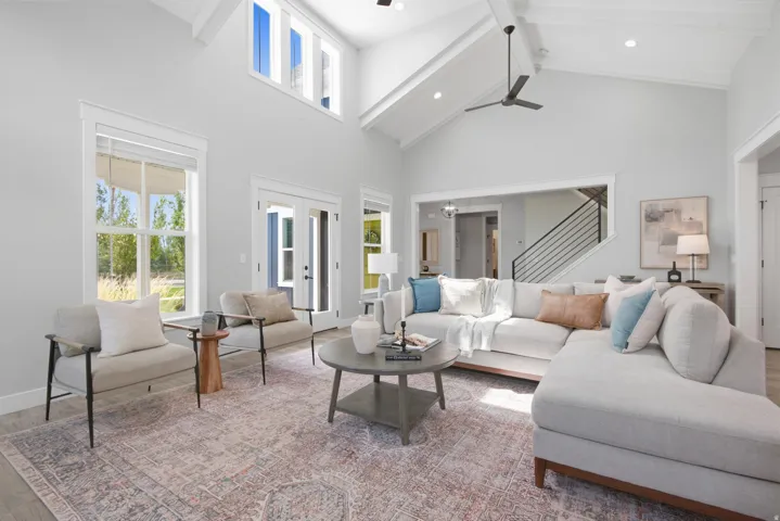 Vaulted ceilings, exposed beams, transom windows, wood-finish flooring, and French doors