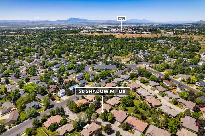 Expansive aerial view showcasing a residential neighborhood with mature trees and established homes