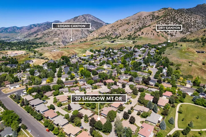 Aerial overview of a residential neighborhood with surrounding mountains