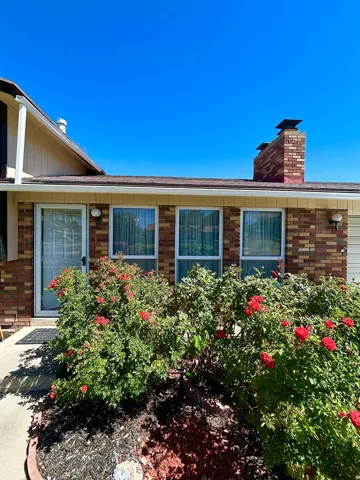 Brick exterior with multiple windows and a prominent chimney structure