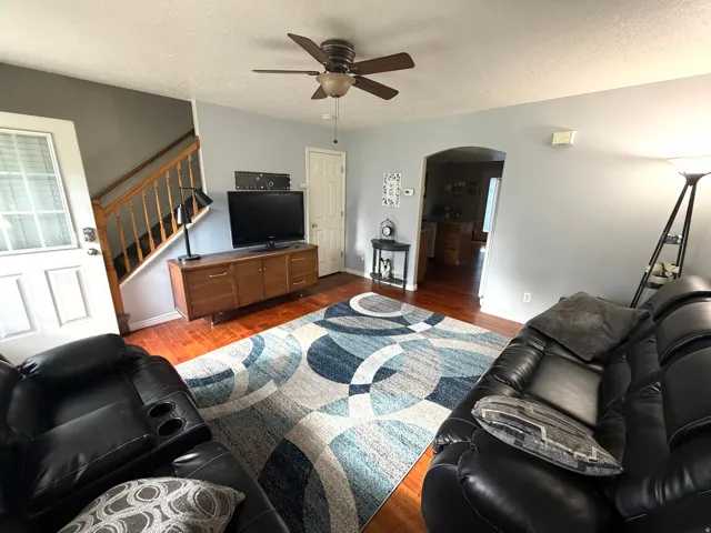 Warm wood-finish flooring complements the light gray wall tones
