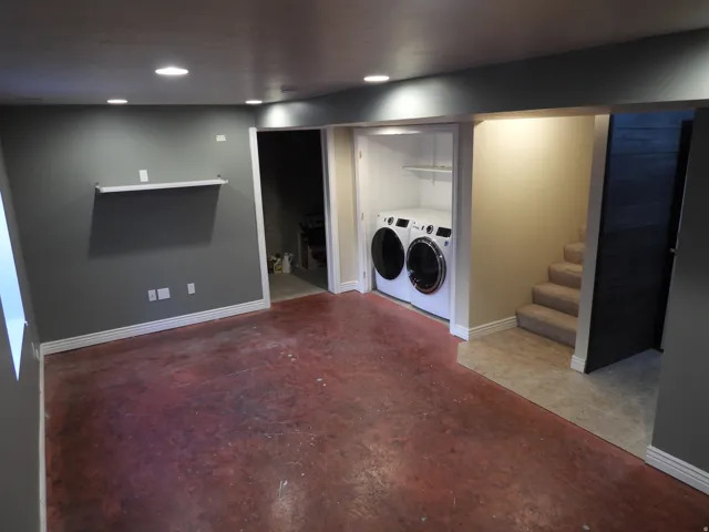 Finished basement area featuring recessed lighting and a floating shelf
