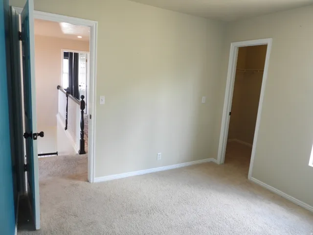 Carpeted interior with light beige walls and white trim
