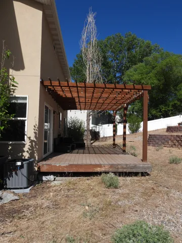 Wood-finish deck with an attached pergola structure