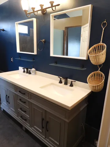 Dual vanity with integrated sinks, light-toned countertop, and matte black fixtures