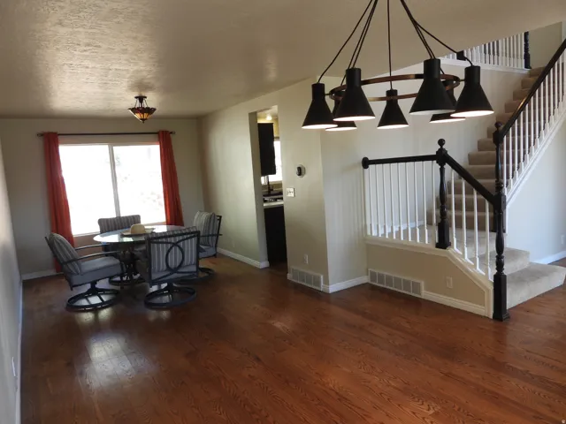 Rich wood-finish flooring complements the neutral wall tones