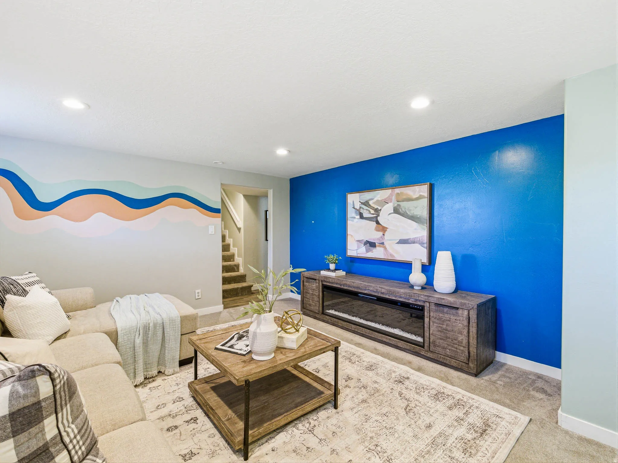 Recreational space featuring recessed lighting and a built-in media console with electric fireplace