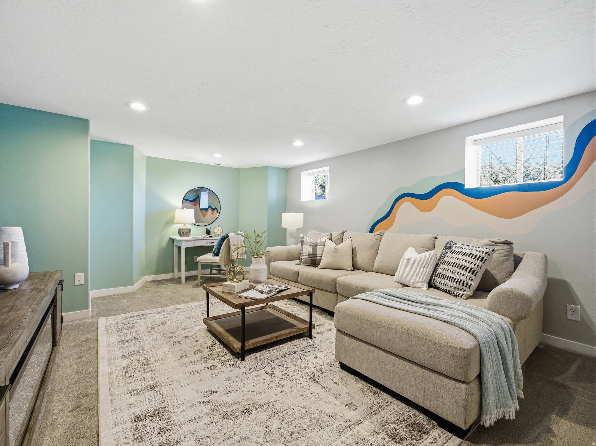 Spacious carpeted living area featuring recessed lighting, a painted accent wall, and multiple windows