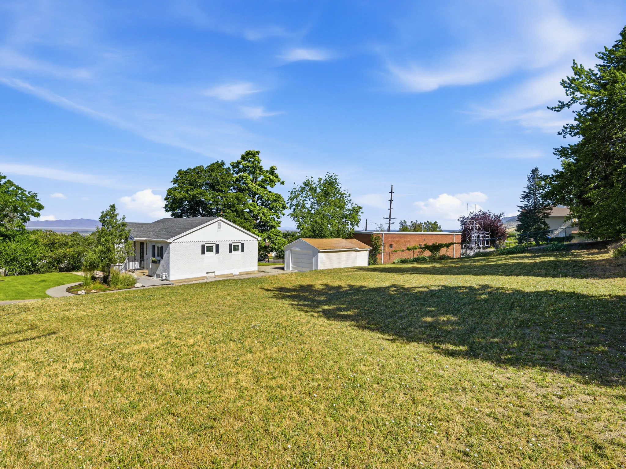 Expansive front yard with a gentle slope
