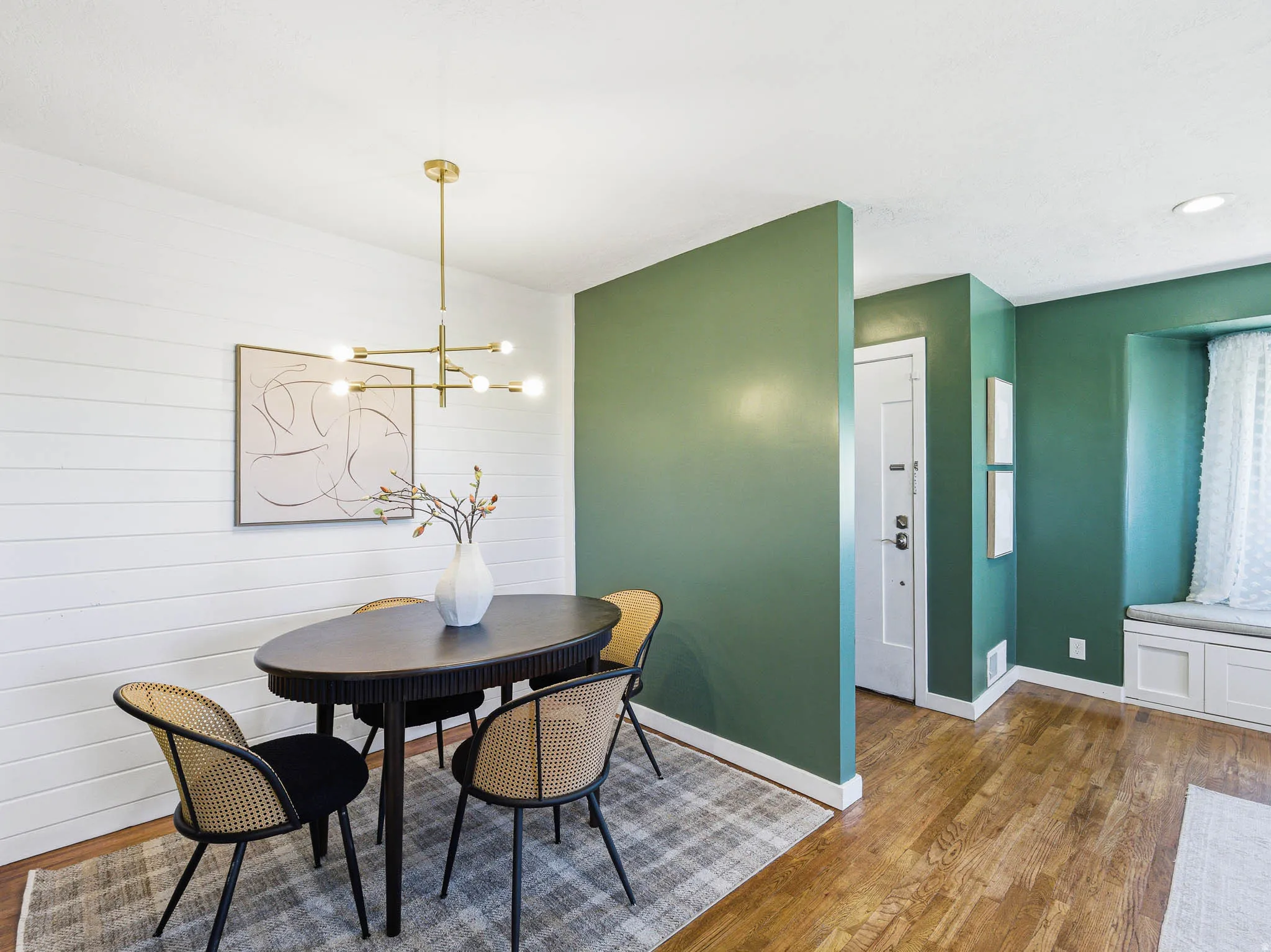 Dining area featuring wood-finish flooring and a contemporary chandelier