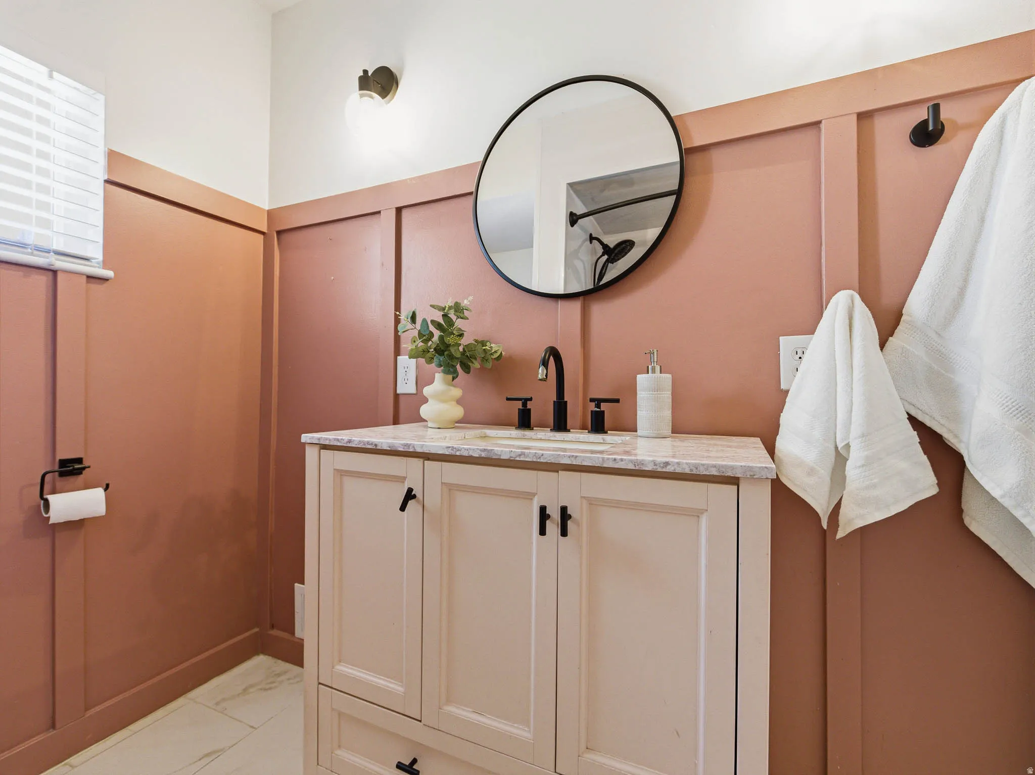Powder room featuring a single vanity with a light-toned cabinet and a light-colored countertop