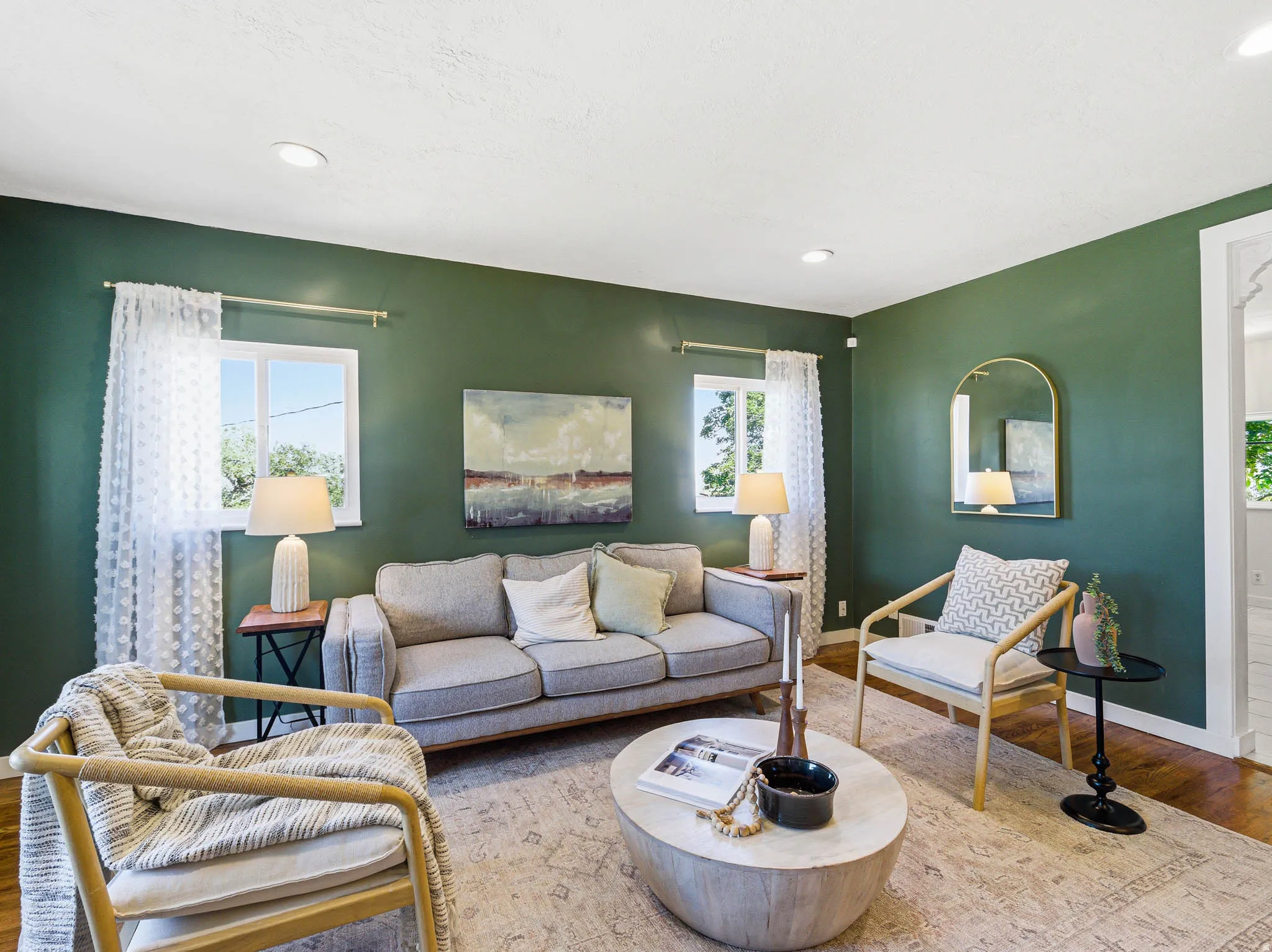 Living area featuring recessed lighting, a decorative wall mirror, two windows, and wood-finish flooring