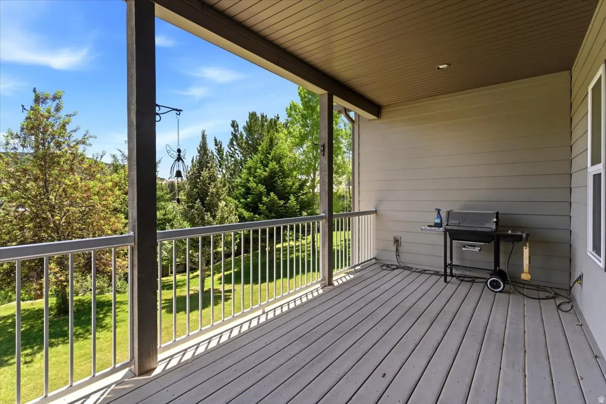Expansive covered deck featuring composite decking and a durable metal railing