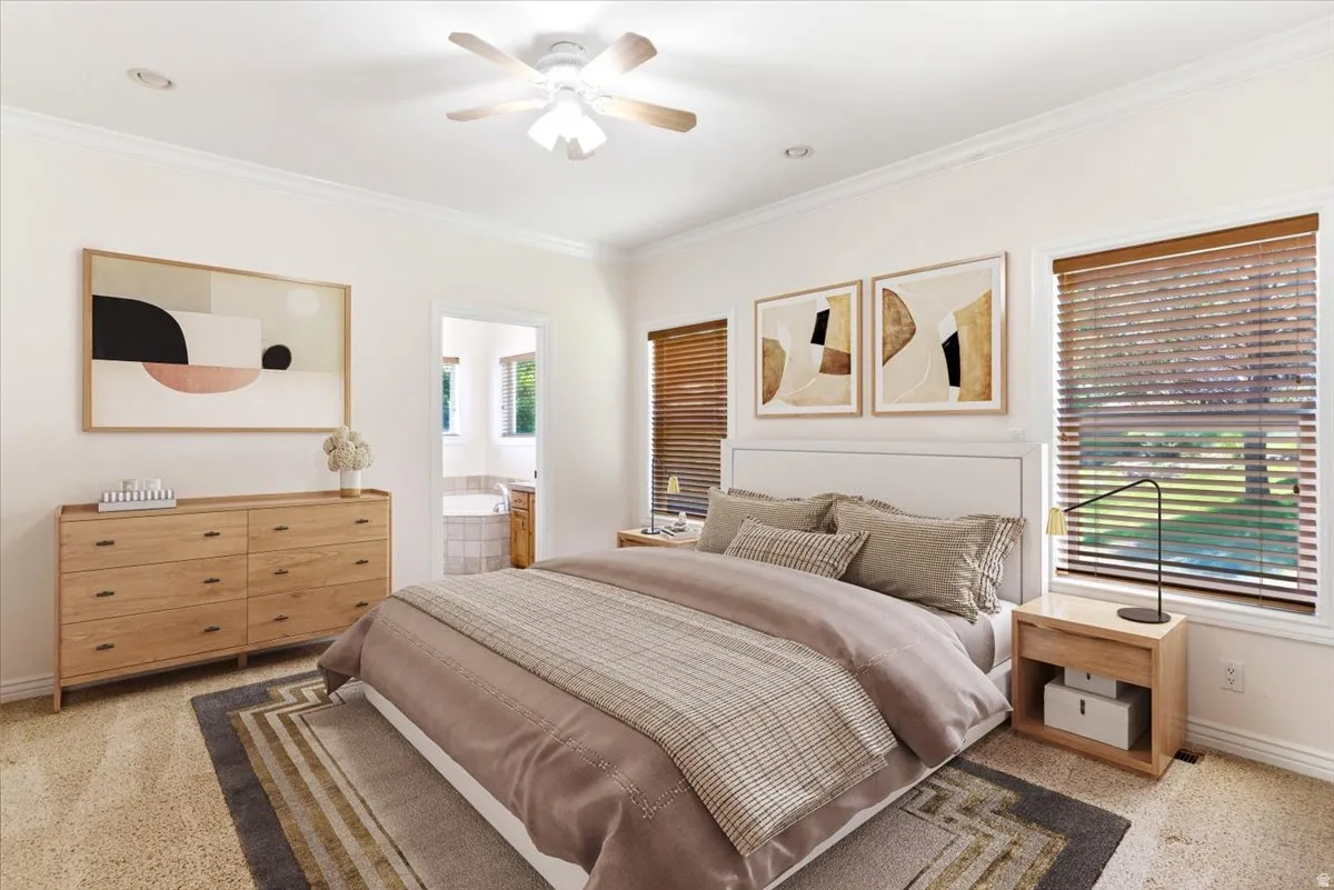 Carpeted bedroom featuring crown molding, a ceiling fan, and recessed lighting. Virtually staged.