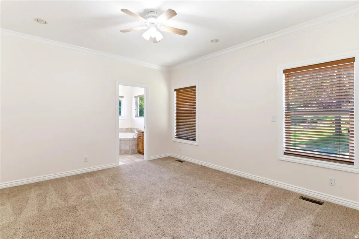 Carpeted room featuring crown molding, recessed lighting, and a ceiling fan