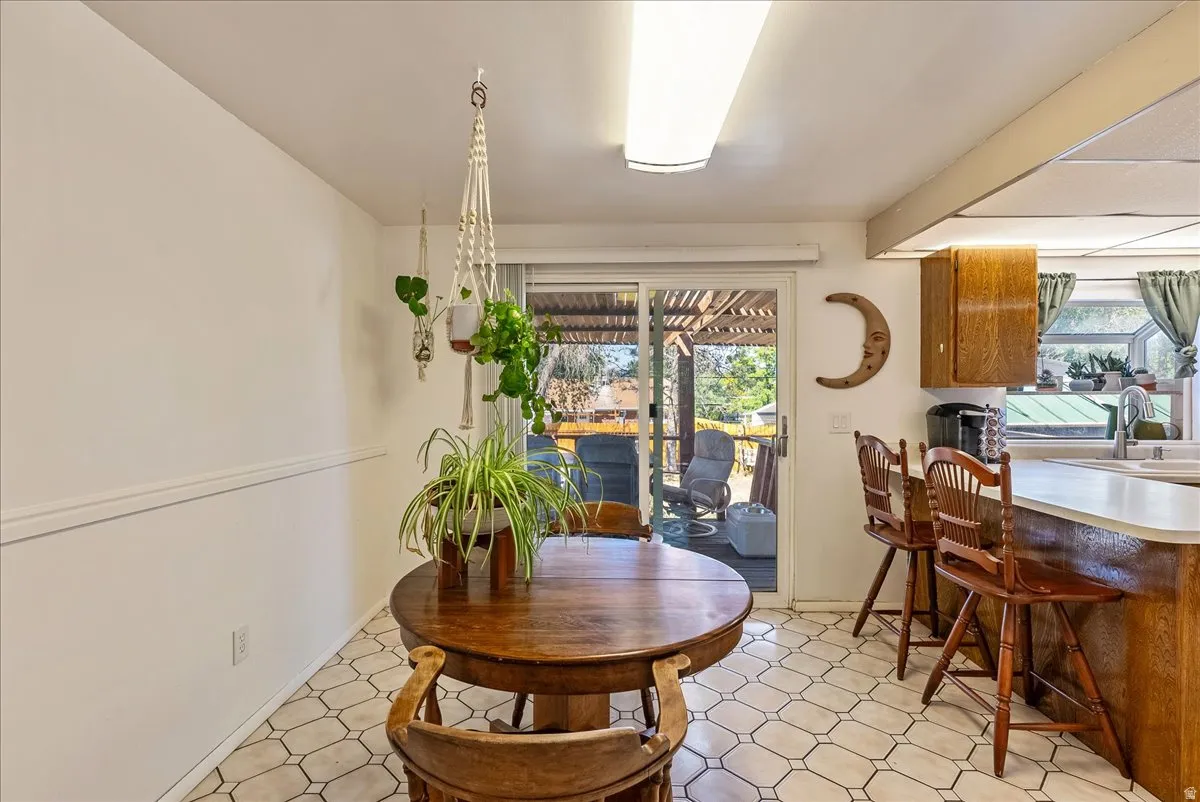 Kitchen area featuring a built-in breakfast bar with seating, wood-finish cabinetry, and a white countertop