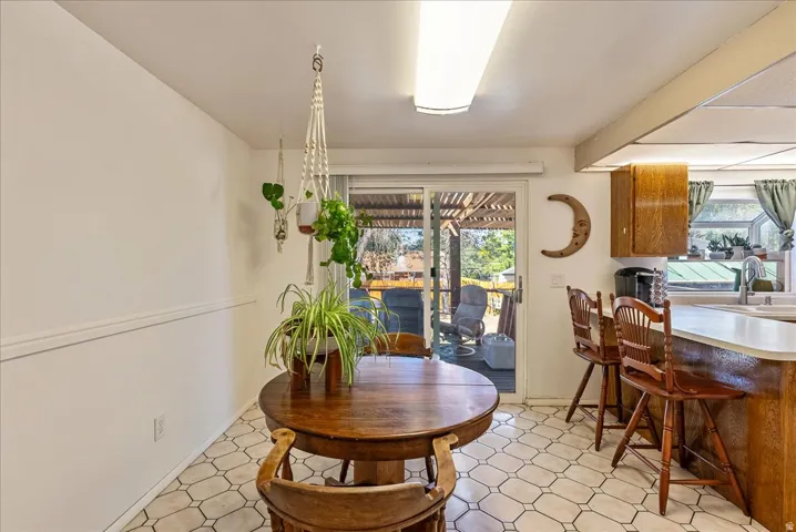 Kitchen area featuring a built-in breakfast bar with seating, wood-finish cabinetry, and a white countertop