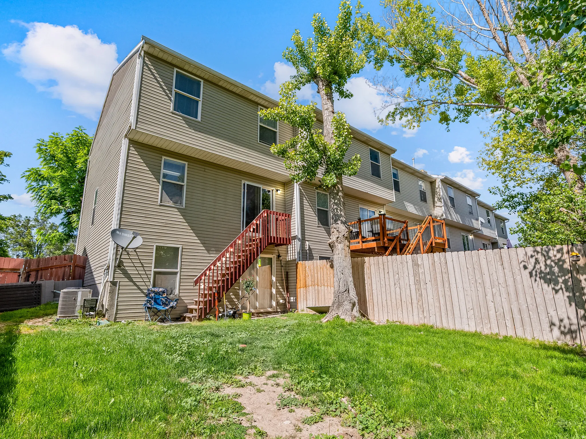 Rear exterior of a multi-story residence featuring horizontal siding