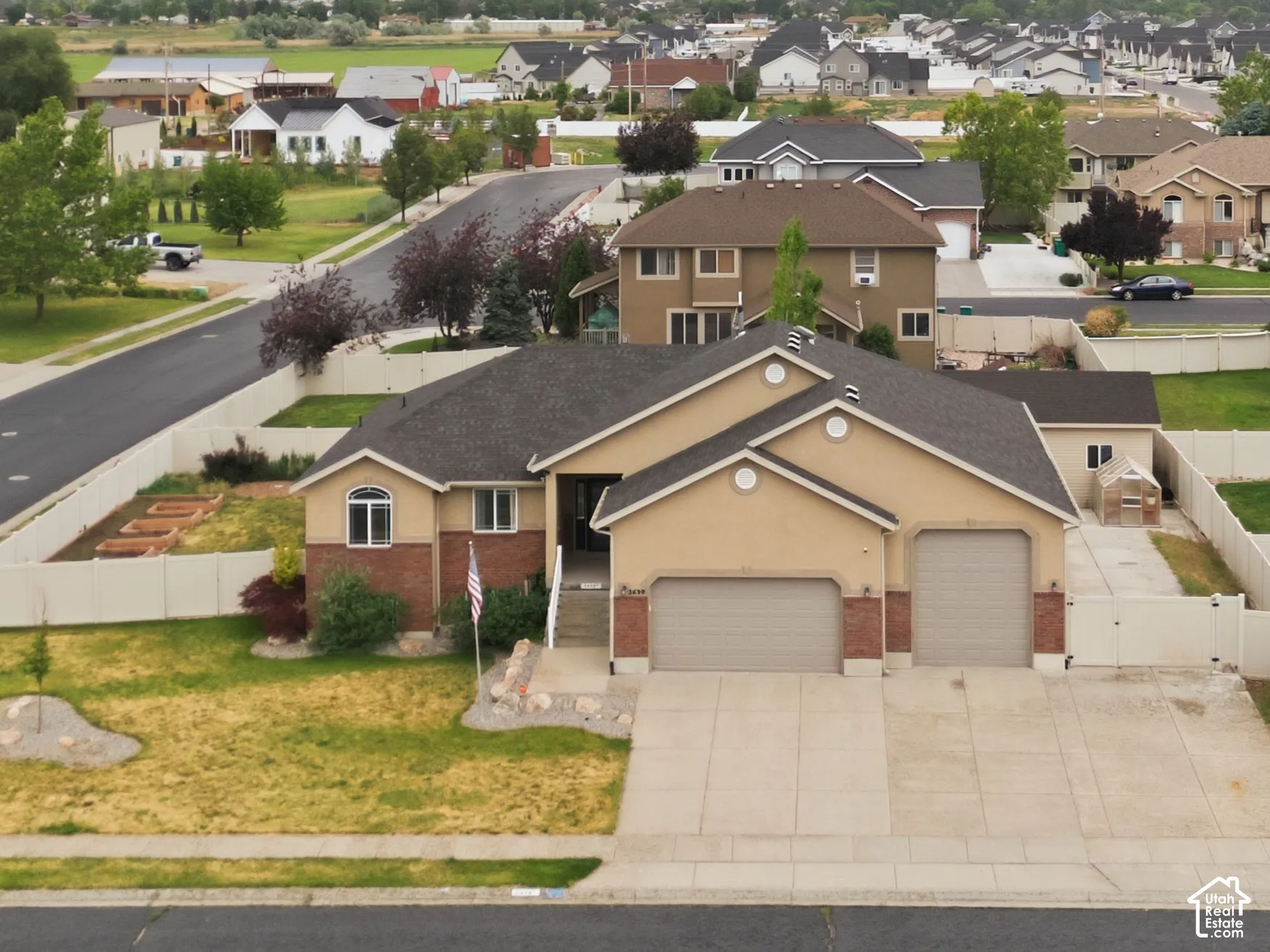 Expansive suburban neighborhood featuring a variety of architectural styles, mature landscaping, and mountain backdrops