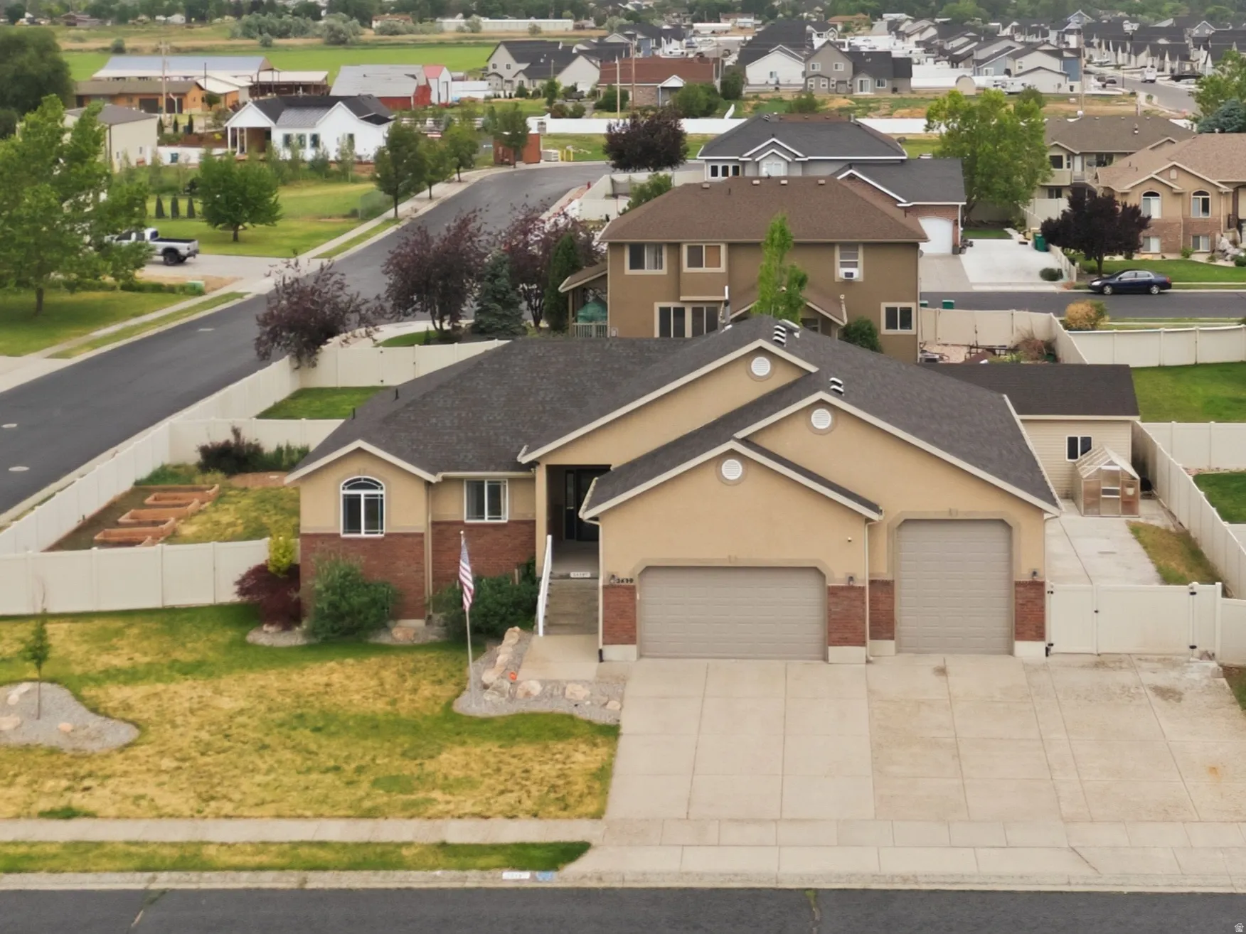Expansive suburban neighborhood featuring a variety of architectural styles, mature landscaping, and mountain backdrops