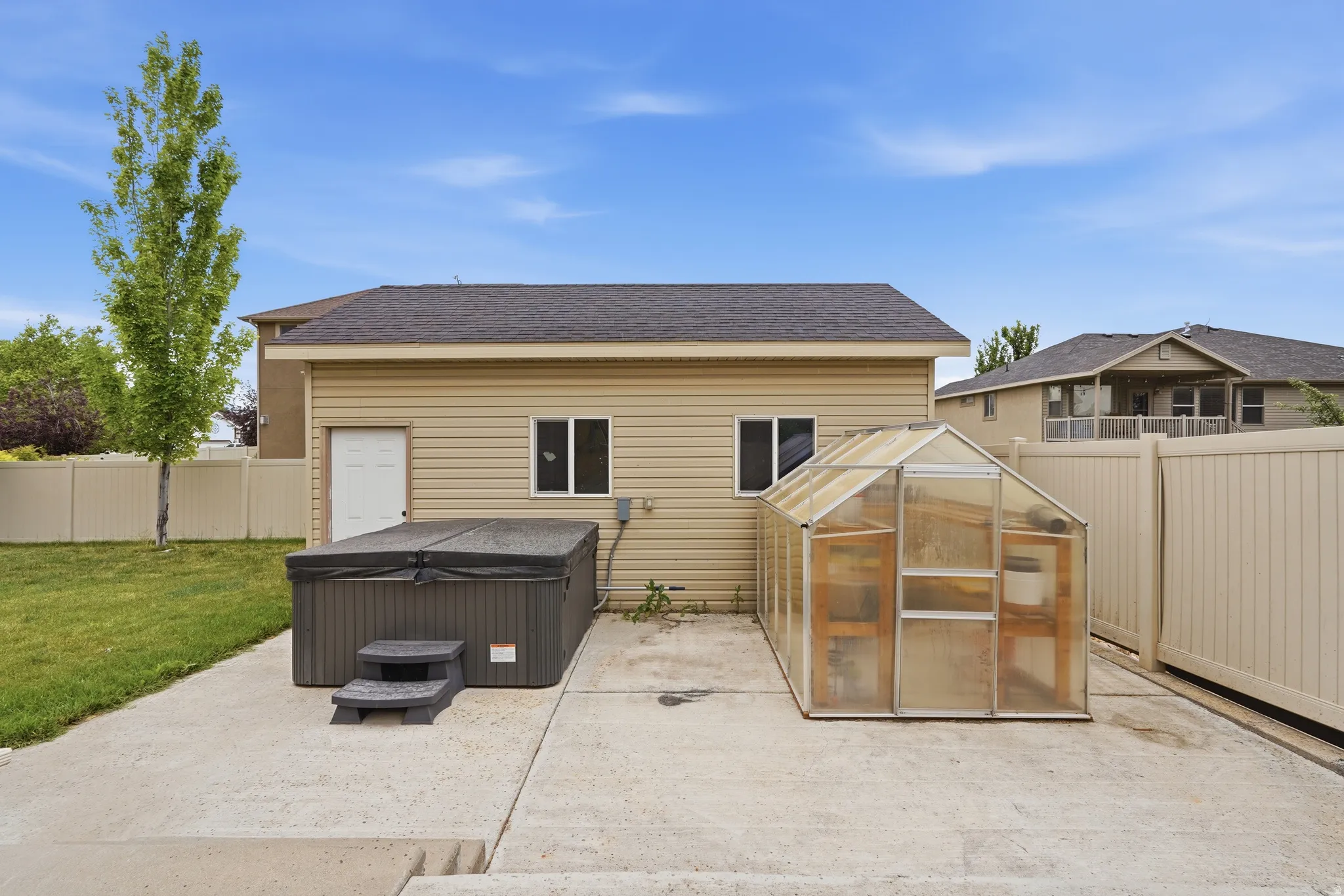 Detached structure with siding exterior and asphalt shingle roof