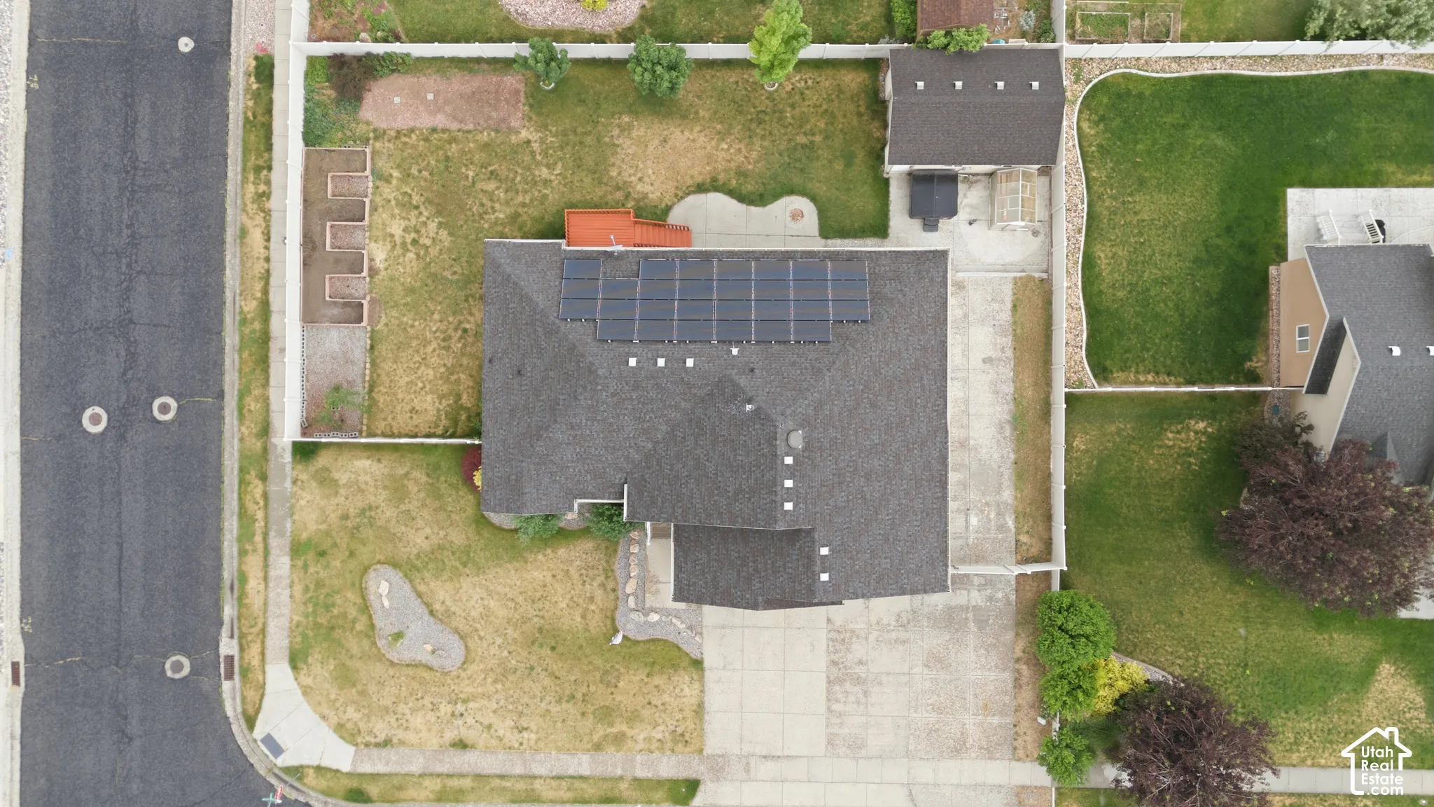 Asphalt shingle roof featuring an array of solar panels