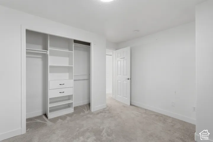 Bright interior space featuring a built-in closet system with shelving, drawers, and hanging rods