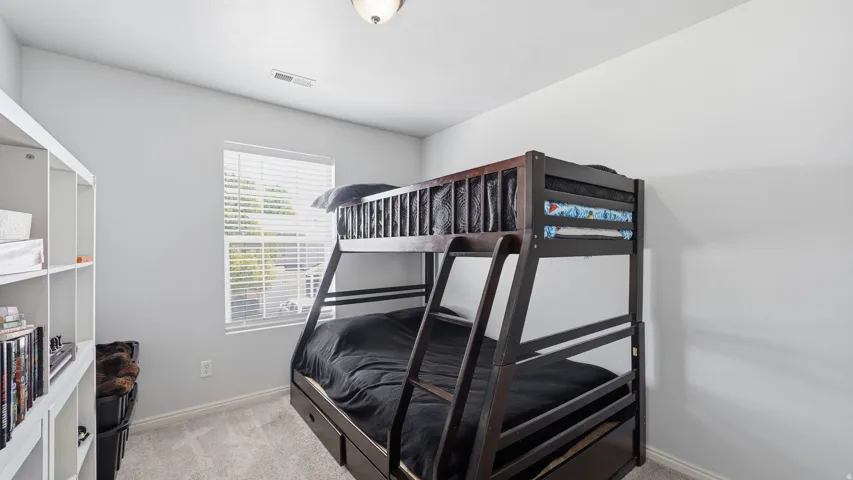 Room featuring soft gray wall paint, recessed ceiling vent, and a single window with white blinds