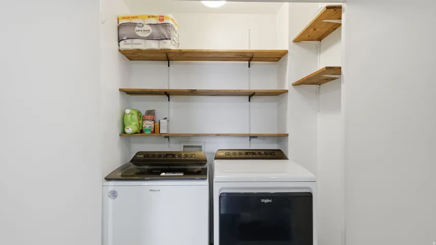 Dedicated laundry area featuring a washer and dryer set