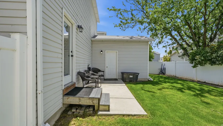 Poured concrete patio with direct outdoor access and a wood deck landing