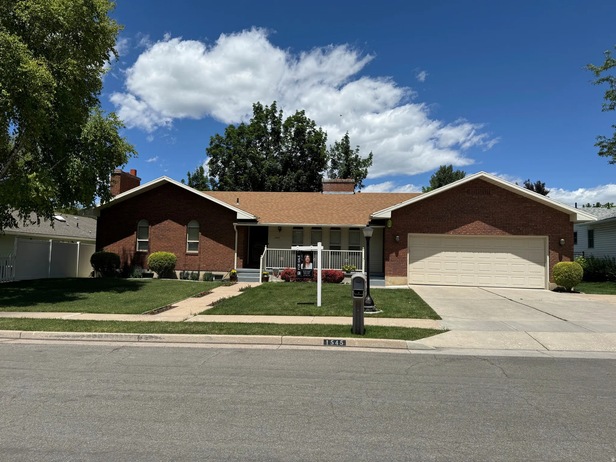 Brick facade residence with a light brown shingle roof