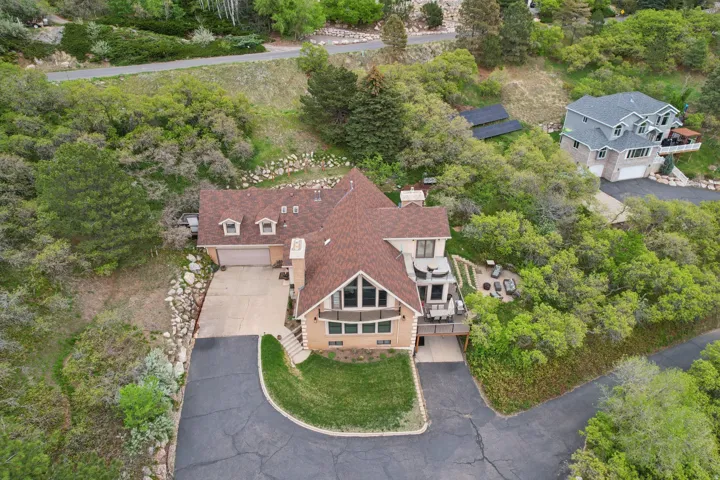 Multi-level residence featuring a brick and siding exterior with a prominent A-frame window design